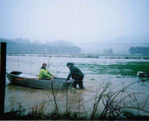 Scott Willis and Tony Puller in a boat in Waitati during the 2006 floods.