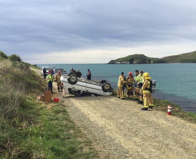 Emergency services at the scene where a car crashed in Aramoana this morning. Photo: Gregor...