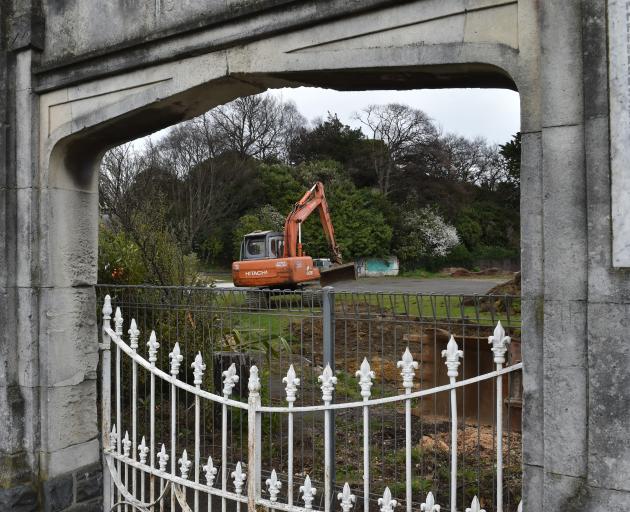 A contractor scrapes back the topsoil at the former site of the High Street School yesterday, so...