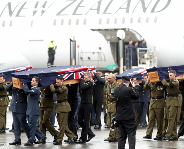 The remains of New Zealand Defence Force personnel repatriated from Malaysia and Singapore arrive at Auckland Airport yesterday. Photo: Getty Images