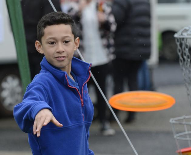 Izayah Taia (8) plays disc golf during the Greater Green Island Get Together event, held at...