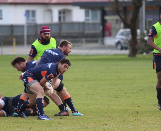 Halfback Nico Costa clears the ball from a ruck during a Southland training session in...