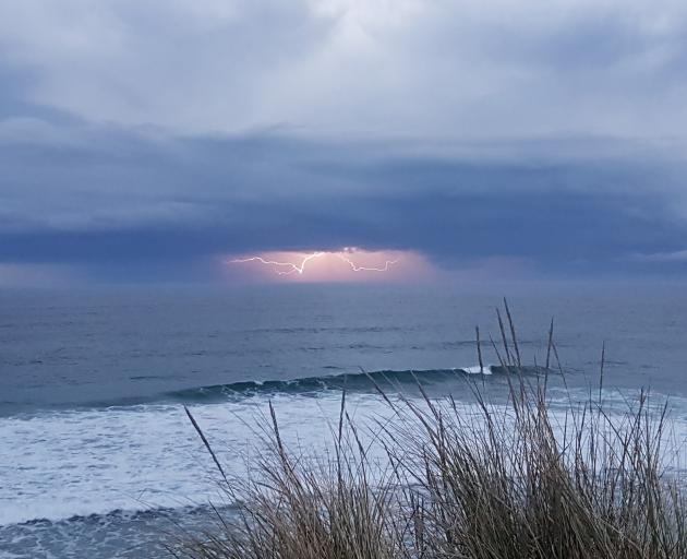 A lightning storm heads out to sea as seen from John Wilson Dr yesterday evening. Photo: Steph Aitken A lightning storm heads out to sea as seen from John Wilson Dr yesterday evening. Photo: Steph Aitken