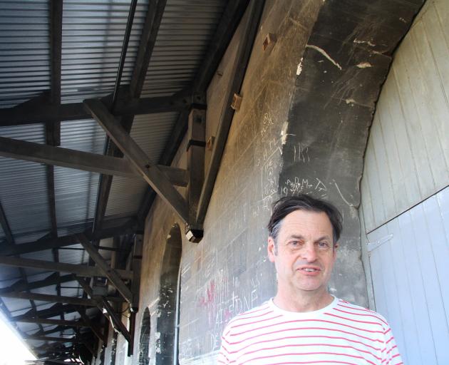 Oamaru Whitestone Civic Trust restoration officer John Baster catches some shade under the first...