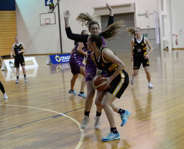 Ajax player Danielle Frost (front) takes on Claudia Flaws, of the South Pacific Magic, in the Dunedin women's premier basketball final at the Edgar Centre last night. Photo: Linda Robertson