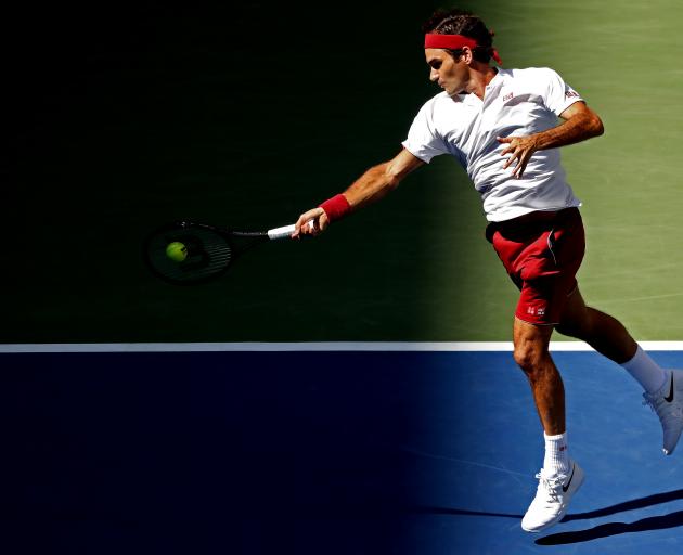 Roger Federer of Switzerland hits a forehand against Nick Kyrgios of Australia. Photo: Reuters