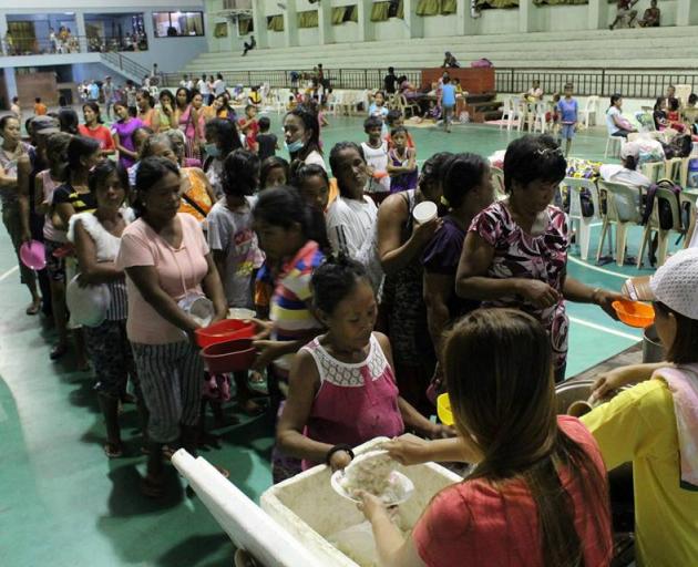 People are seen inside an evacuation centre in preparation for Typhoon Mangkhut in Cagayan,...