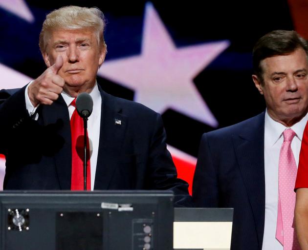 Donald Trump gives a thumbs up as his former campaign chairman Paul Manafort looks on. Photo:...