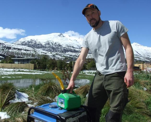 Self-sufficient: Scheelite Ave resident James Pocock with his generator. Photo: Mountain Scene