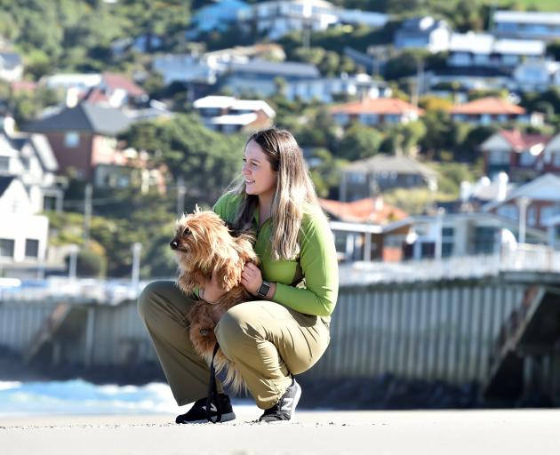 Department of Conservation ranger Jess Triscott keeps close tabs on Ralph the dog at St Clair...
