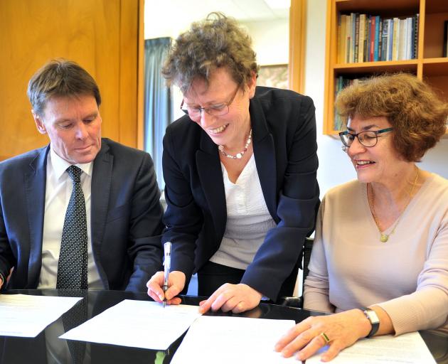 Goethe Institut national German adviser Heike Papenthin signs a scholarship agreement with John McGlashan College principal Neil Garry and acting principal of Columba College Jenness Riethmaier. Photo: Christine O'Connor