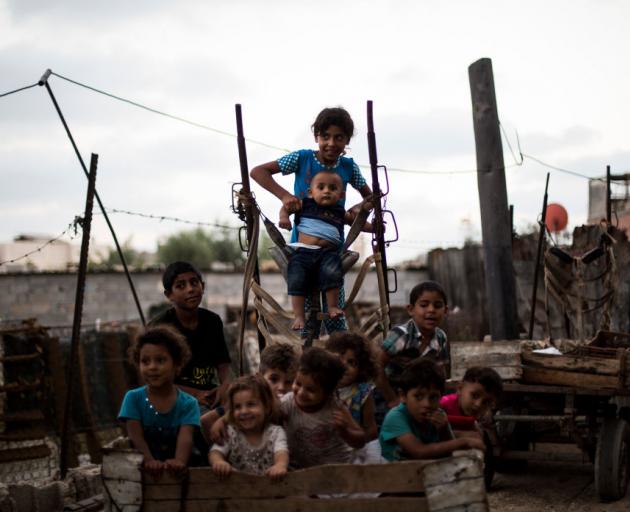 Palestinian refugee kids seen playing outside their temporary home in the northern Gaza Strip...