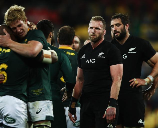 A dejected looking Kieran Read and Sam Whitelock look on as South Africa celebrate. Photo: Getty...