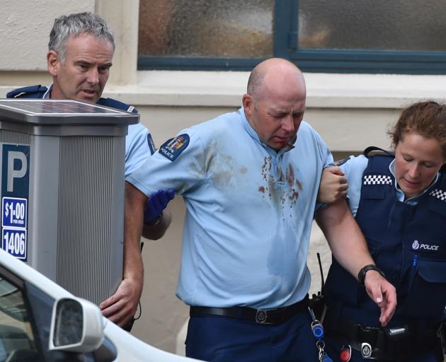 Sergeant Nathan White (centre) is supported by Constable Brent Mitchell and Aime Manning after...