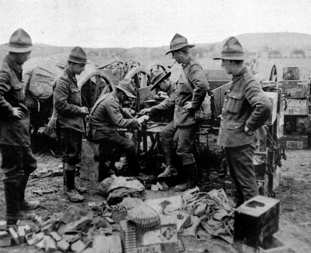 New Zealand machine gunners fitting belts with cartridges. - Otago Witness, 4.9.1918. 