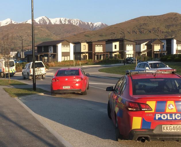 Police officers leaving a property on Jones Ave, Lower Shotover, after executing a search warrant yesterday morning. Photo: Guy Williams
