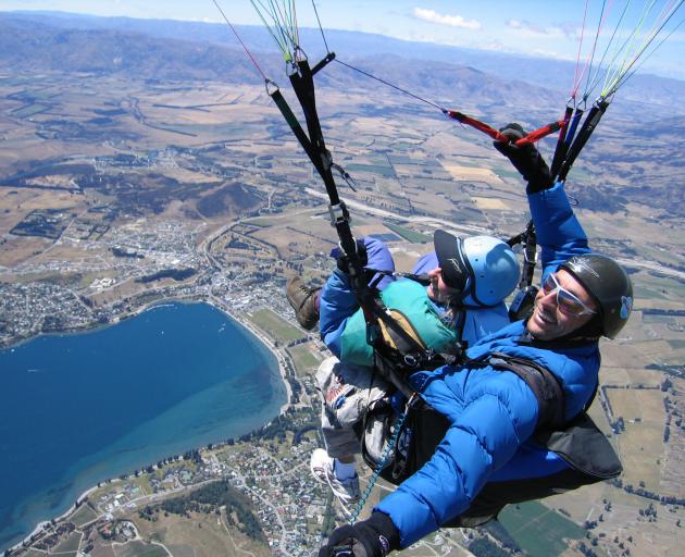 Booming tourism is one of the prime contributors to Otago's good run of regional economic results; pictured, tandem paragliding above Mt Roy, Wanaka. Photo: Hugo Brighouse (Pilot)