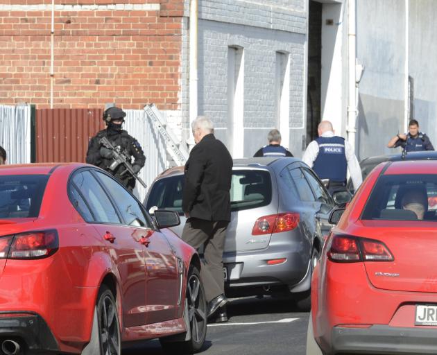 Police surround a warehouse in South Dunedin. Photo: Gerard O'Brien