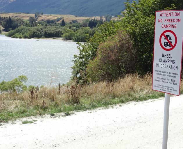 Signs at the entrance to the northern end of Lake Hayes advise freedom campers they’re no longer...