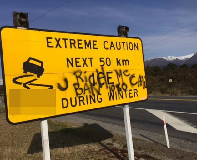 Another sign graffitied by 1080 activists on the Desert Rd SH1. Photo: Supplied