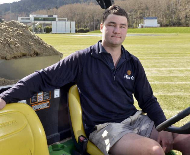 University of Otago Oval turf manager Jayden Tohill does some top dressing at the venue yesterday...