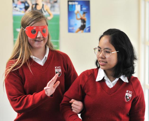 Kaikorai Valley College year 10 pupil Emma Hedges needs a guiding hand from fellow pupil Katha Isip as she tries to find her way while experiencing the effects of cataracts through cataract simulation goggles. Photo: Christine O'Connor