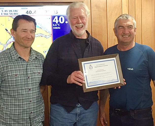 Wanaka Search and Rescue stalwart Phil Melchior (centre) receiving a life membership of the...