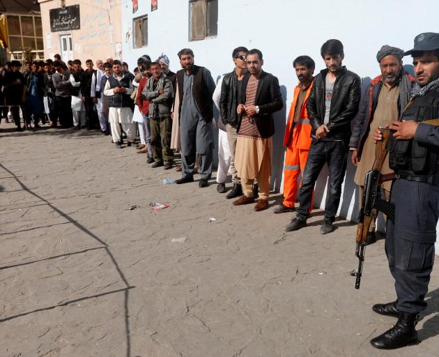 Afghan men line up to vote in Kabul, Afghanistan. Photo: Reuters