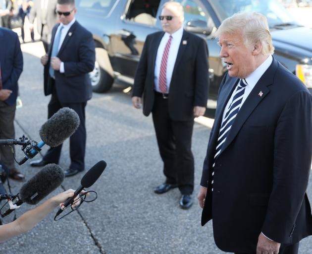 US President Donald Trump speaks to reporters before departing Nevada, where he appeared at a...