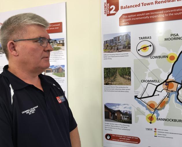 Cromwell Community Board chairman Neil Gillespie looks over one of the options for residential...