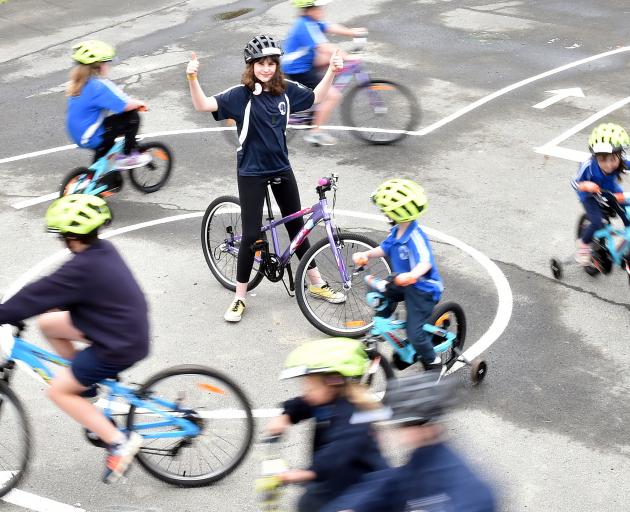 Carisbrook School pupil Ramona Mahutte (13) celebrates the opening of a new bike tracks at the...