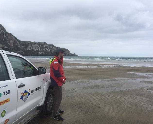 Otago surf life saving SAR coordinator Max Corboy, of Dunedin, awaits the return of four IRBs at Purakaunui Bay in the Catlins. Photo: Richard Davison
