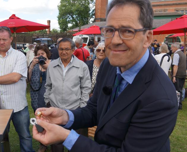 British jewellery valuer John Benjamin examines pieces on the BBC’s Antiques Roadshow television show. Photo: BBC