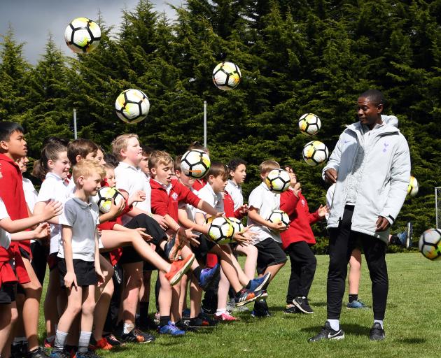 Tottenham Hotspur international development coach Anton Blackwood shows the pupils of Fairfield...