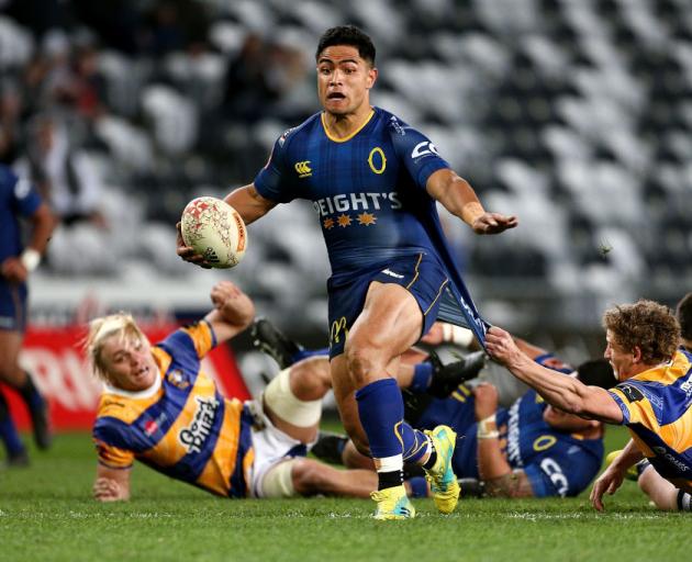 Josh Ioane of Otago breaks the tackle of Richard Judd of Bay of Plenty during the round eight...