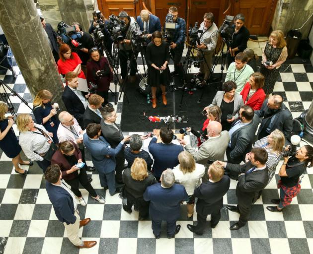 Surrounded by senior National Party MPs, party leader Simon Bridges speaks to media after a caucus meeting at Parliament yesterday. Photo: Getty Images