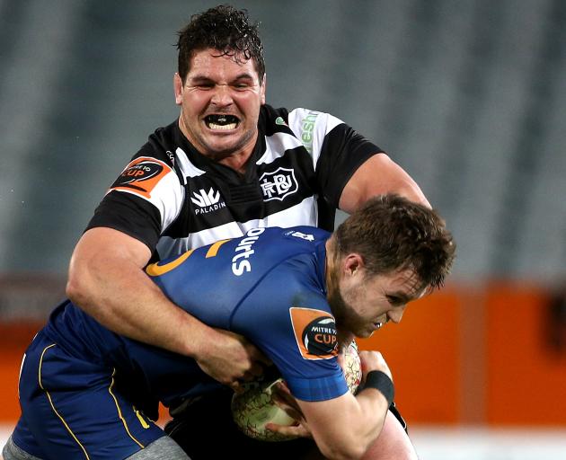 Michael Collins of Otago is tackled by big Ben May from Hawke's Bay during the first half at...