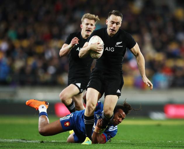 Ben Smith breaks the tackle of a French player earlier this year. Photo: Getty Images