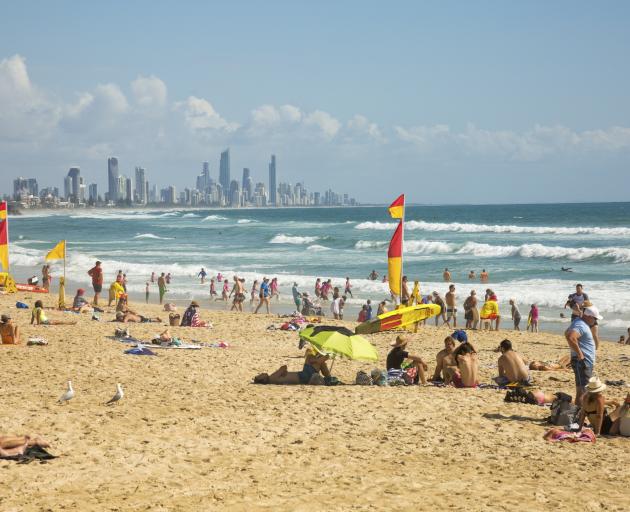 Beachgoers at Burleigh Heads with Surfers Paradise in the background at the Gold Coast, Queensland, Australia. Photo: Getty Images