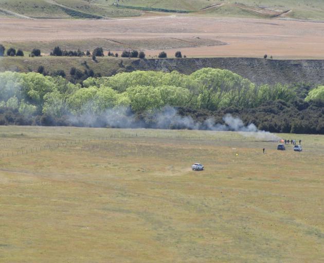 Smoke rises from the wreckage after a helicopter crashed near the Wanaka airport OCT 18 2018. Photo: Mark Price