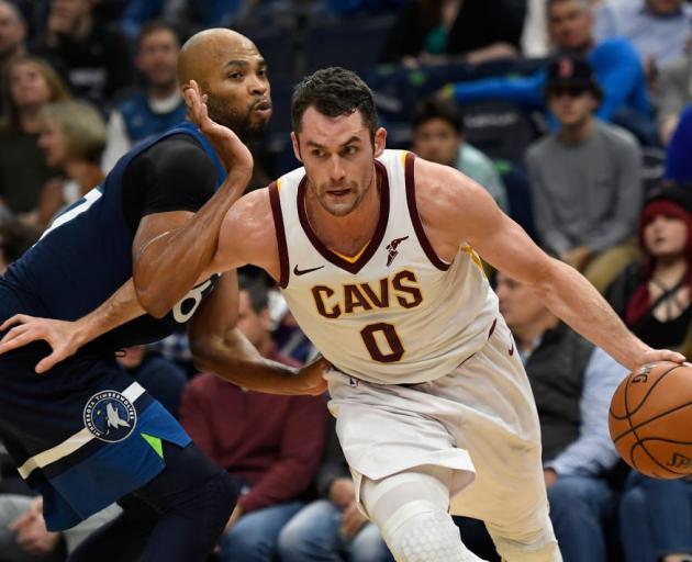 Cleveland Cavaliers forward Kevin Love drives past Minnesota Timberwolves forward Taj Gibson last...