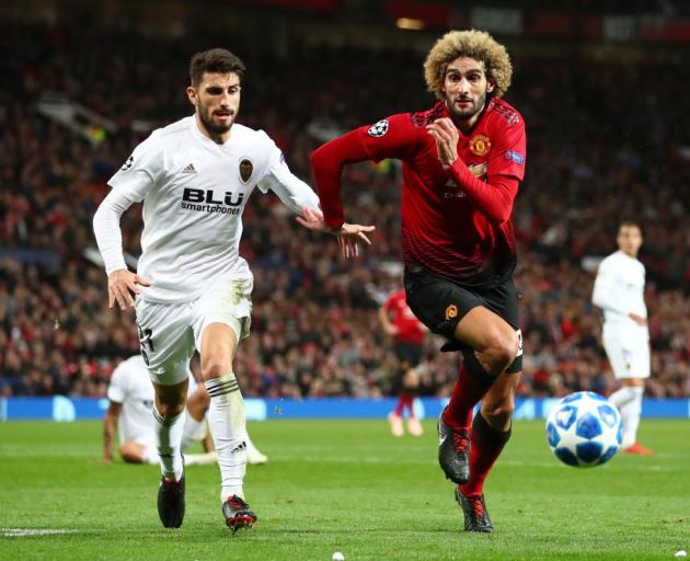 Marouane Fellaini of Manchester United is challenged by Cristiano Piccini of Valencia during...