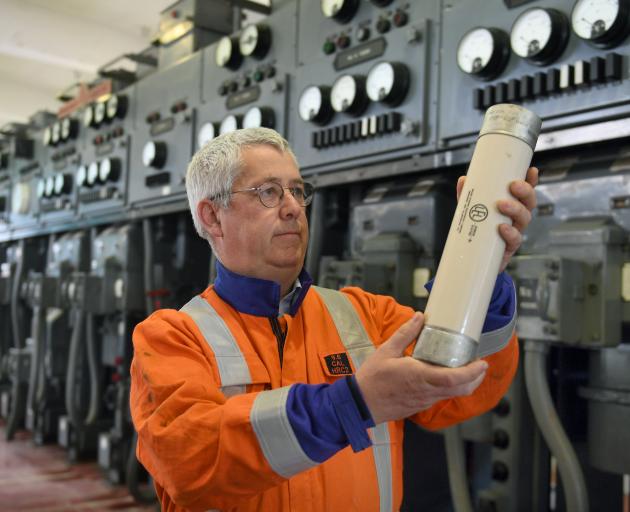 Aurora asset reliability engineer David Paterson holds a 6.6kV, 160amp HRC fuse at the soon-to-be-decommissioned Neville St substation. Photo: Stephen Jaquiery