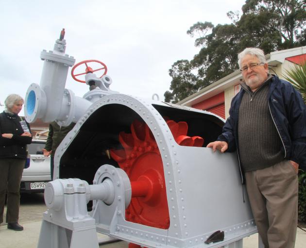 Oamaru heritage engineering advocate Bruce Comfort with an original Pelton wheel turbine which he...