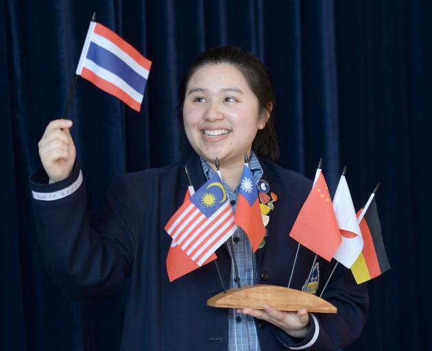 Otago Girls' High School international prefect Pear Sae-Lee waves the flag of her home country, Thailand. Photo: linda Robertson