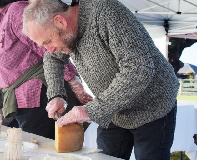 Cheesemonger Martin Aspinwall, of Canterbury Cheesemongers, cuts cheese at last year's amateur cheesemakers' competition. Photo: Supplied