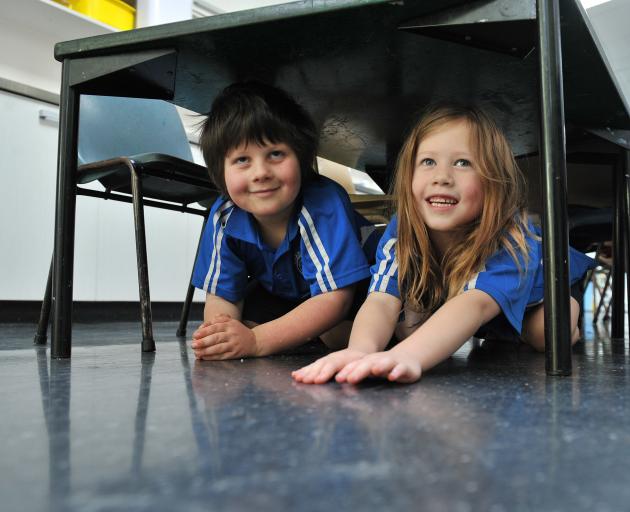 Carisbrook School pupils Jake Cairns (6) and Makayla Donnelly (6) duck for cover in Dunedin as...