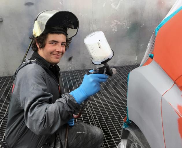World Skills New Zealand national competition gold medal winner Callum Dodds paints a car in a spray booth in Harrow Motor Body Works in Dunedin last week. Photo: Shawn McAvinue