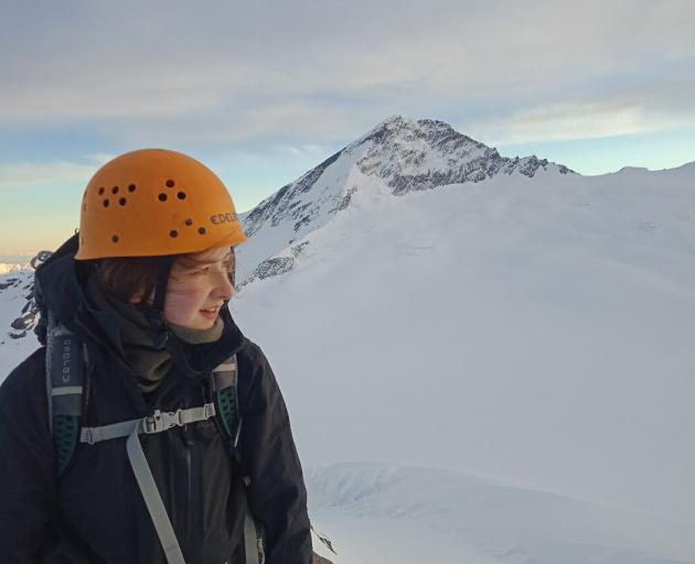 University of Otago student Maddy Whittaker on the Mt French summit, with Mt Aspiring in the background. Next month, she will walk from Bluff to the top of the South Island to raise money for Outward Bound. Photo: Supplied