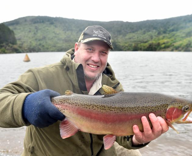 Otago Fish & Game Council field officer and hatchery manager Steve Dixon prepares to release...